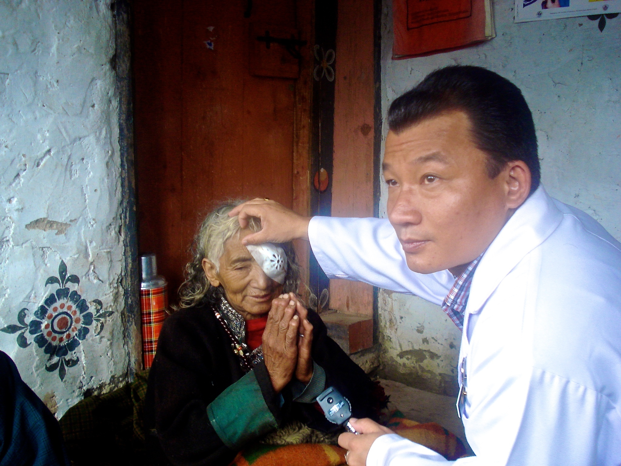 Dr Bhim Rai with patient in Bhutan