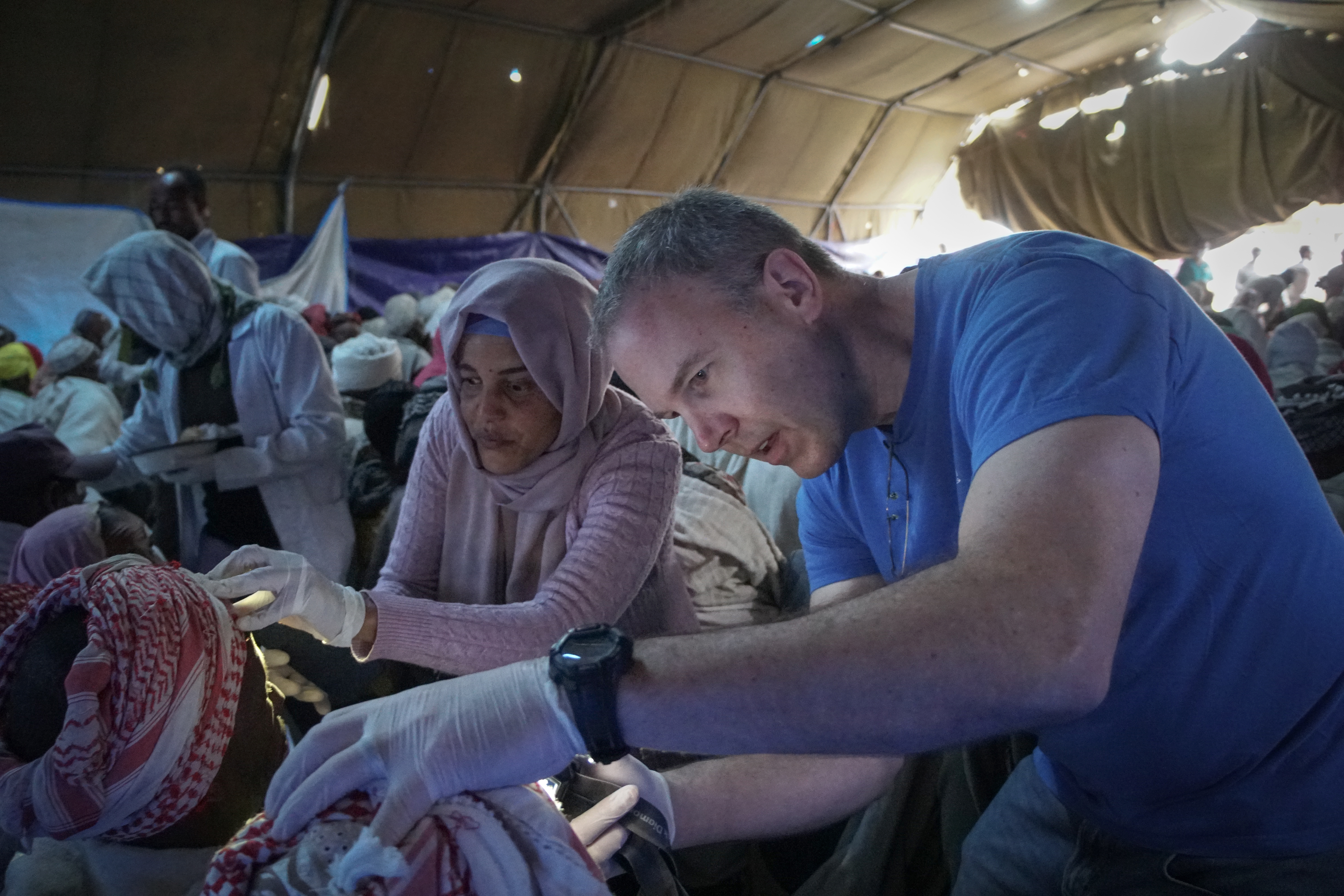 Dr. Sam Cady examining a patient post-surgery. Ethiopia, 2019.
