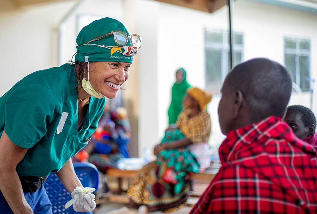 Volunteer Ophthalmologist smiles with patient whose blindness was cured
